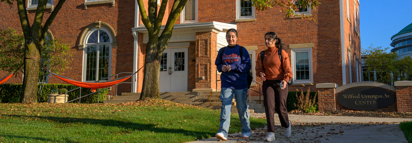 Kiran Bathla and a fellow student walking on campus