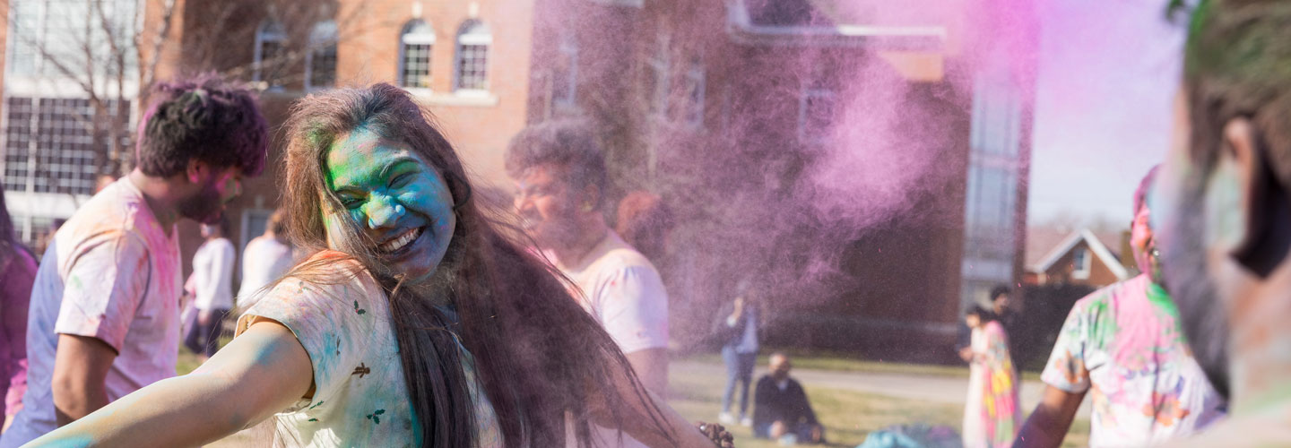 Student covered in colors during Holi celebration