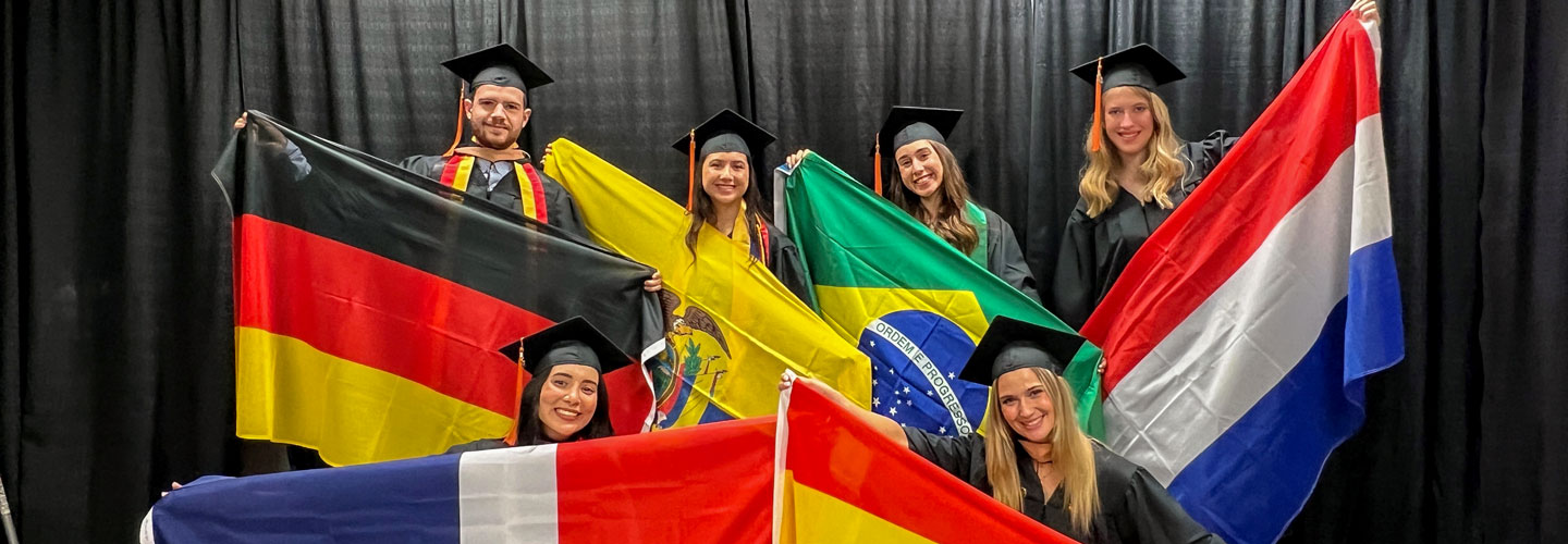 International Students holding flags at commencement